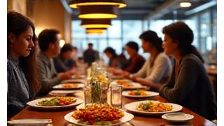 Still from a restaurant TV commercial showing a bustling dining room and delicious-looking dishes.